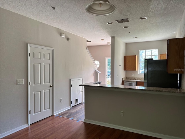 2061 Fiesta Ridge Ct, Tampa, FL 33604 - kitchen featuring stainless steel dishwasher, a textured ceiling, visible vents, freestanding refrigerator, and dark wood-type flooring