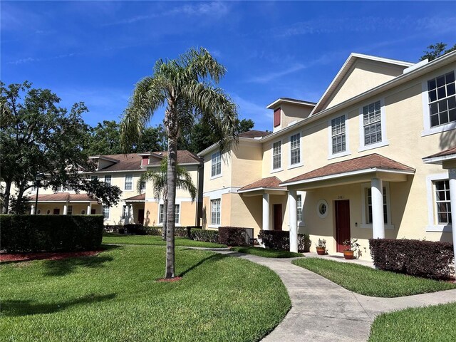 2061 Fiesta Ridge Ct, Tampa, FL 33604 - view of front facade featuring a front lawn and stucco siding