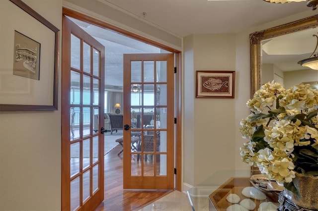 doorway to outside featuring french doors and baseboards