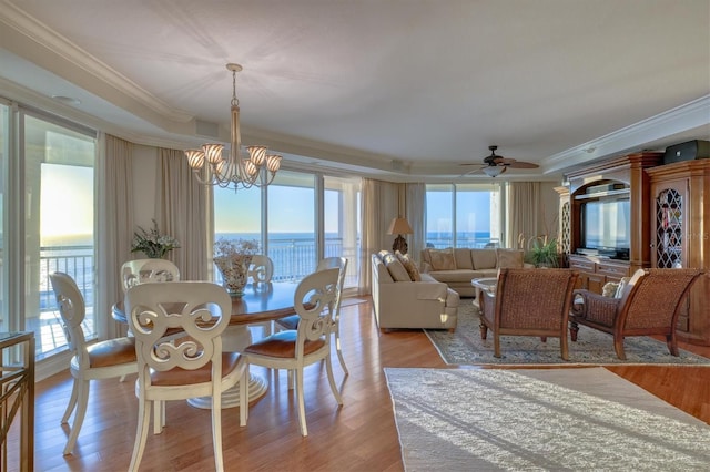 dining room with plenty of natural light, light wood-type flooring, and ornamental molding