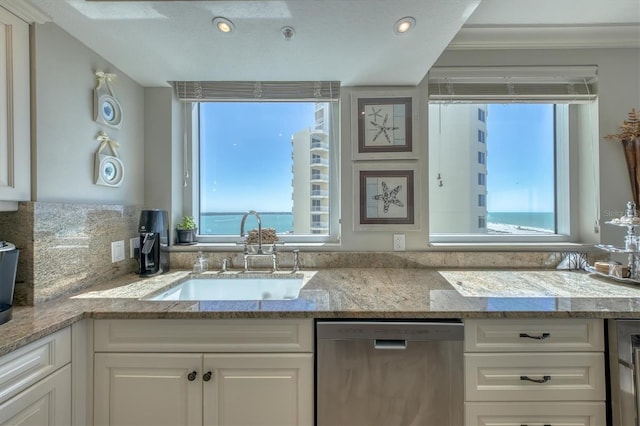 kitchen featuring a sink, white cabinetry, and dishwasher
