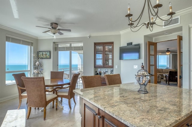 dining room with crown molding, ceiling fan with notable chandelier, light tile patterned floors, and visible vents