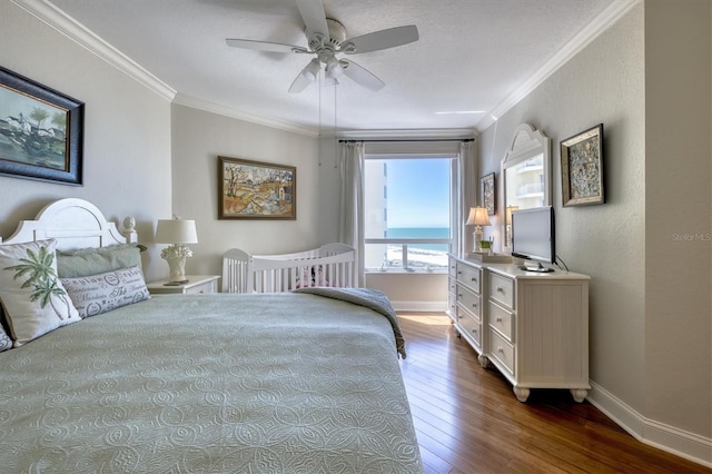 bedroom featuring dark wood finished floors, baseboards, and ornamental molding