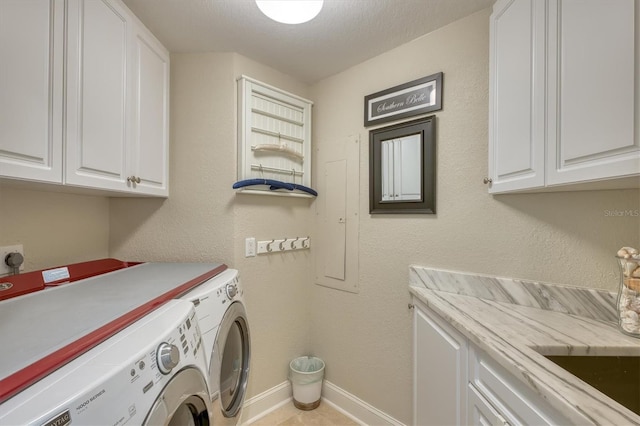 washroom featuring washer and dryer, baseboards, and cabinet space