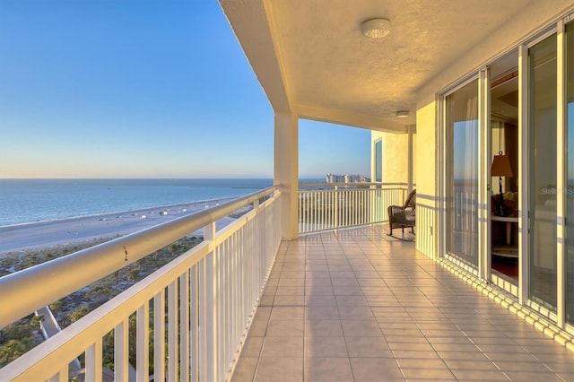 balcony with a view of the beach and a water view