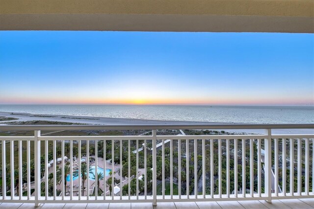 balcony featuring a water view and a view of the beach