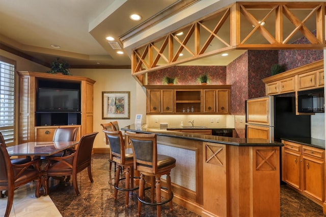 kitchen with open shelves, a sink, dark countertops, black microwave, and recessed lighting