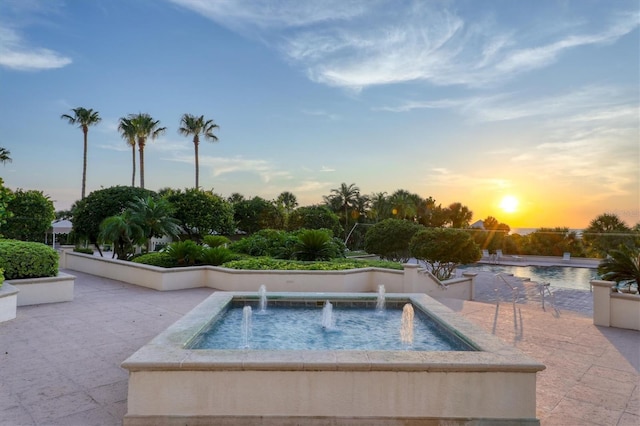 view of pool at dusk