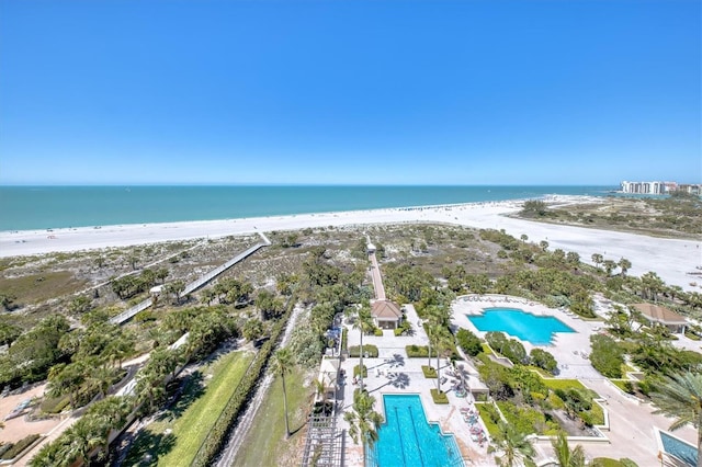 drone / aerial view featuring a water view and a view of the beach