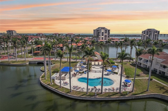 6277 Bahia Del Mar Blvd Unit 210, Saint Petersburg, FL 33715 - pool at dusk with a water view, a community pool, a patio area, and a view of city