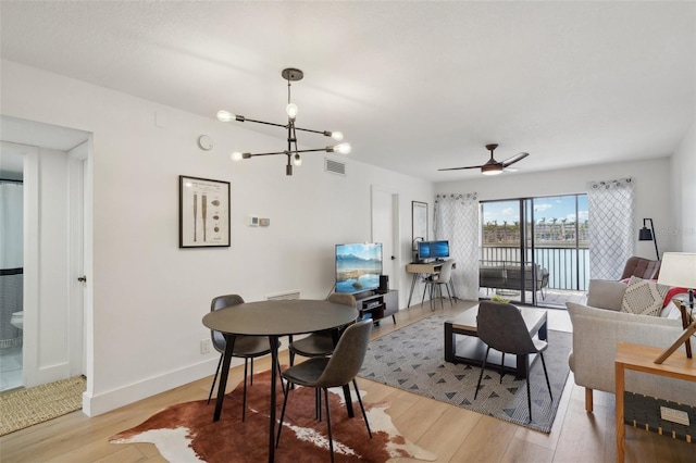 6277 Bahia Del Mar Blvd Unit 210, Saint Petersburg, FL 33715 - dining area featuring a chandelier, light wood finished floors, baseboards, and a ceiling fan