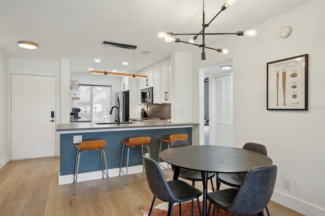 6277 Bahia Del Mar Blvd Unit 210, Saint Petersburg, FL 33715 - dining space with a chandelier, light wood finished floors, baseboards, and recessed lighting