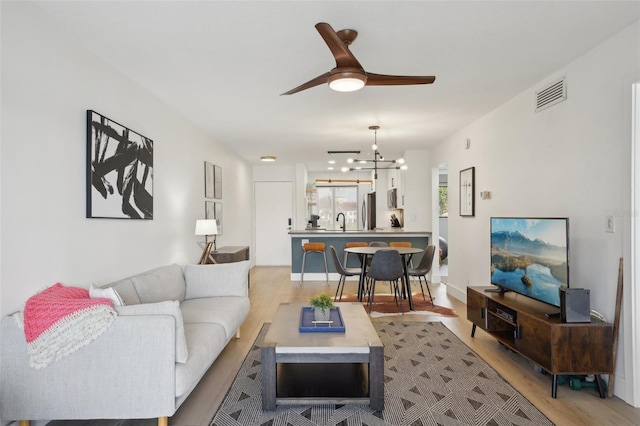 6277 Bahia Del Mar Blvd Unit 210, Saint Petersburg, FL 33715 - living room featuring light wood-type flooring, a chandelier, and a ceiling fan