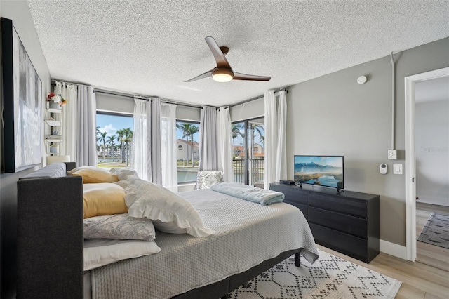6277 Bahia Del Mar Blvd Unit 210, Saint Petersburg, FL 33715 - bedroom with a textured ceiling, ceiling fan, light wood-style floors, and baseboards