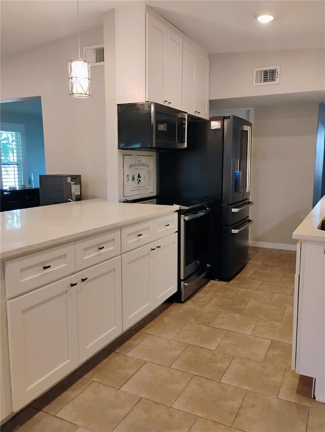 11233 51st Ave N, Saint Petersburg, FL 33708 - kitchen featuring visible vents, white cabinetry, light countertops, and pendant lighting