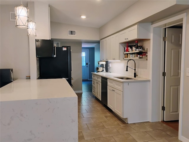 11233 51st Ave N, Saint Petersburg, FL 33708 - kitchen with visible vents, white cabinets, a sink, light countertops, and black appliances