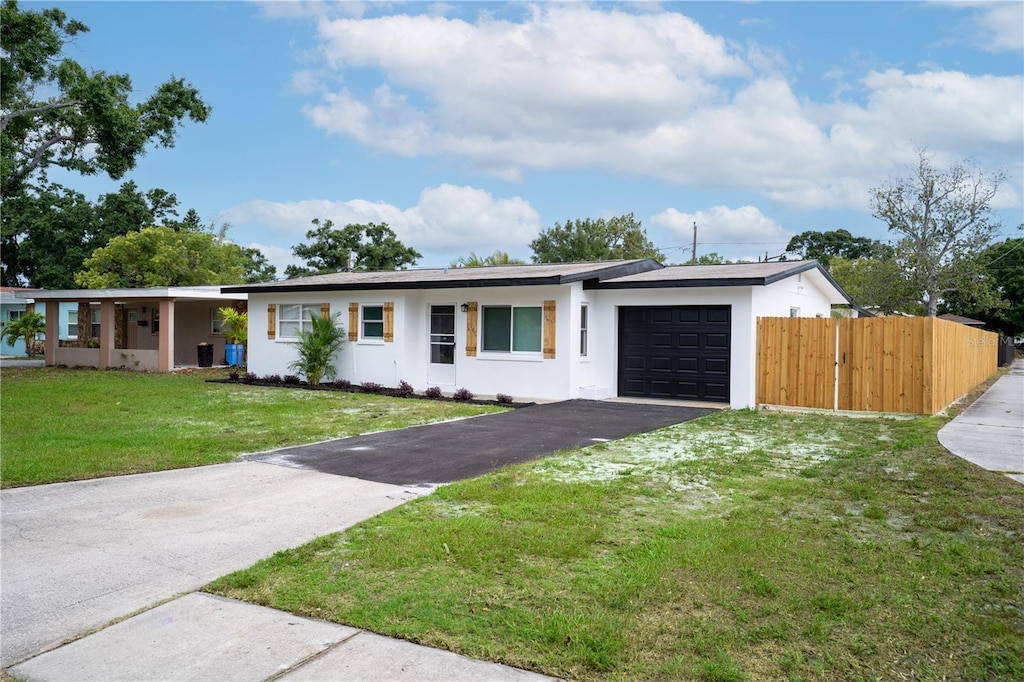 4601 71st Ave N, Pinellas Park, FL 33781 - ranch-style house with a garage, stucco siding, and driveway
