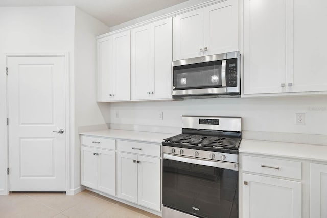 14180 Samoa Hill Ct, Riverview, FL 33569 - kitchen with appliances with stainless steel finishes, light countertops, white cabinets, and light tile patterned flooring