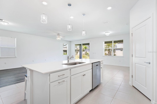 14180 Samoa Hill Ct, Riverview, FL 33569 - kitchen featuring stainless steel dishwasher, a sink, open floor plan, light tile patterned flooring, and light countertops