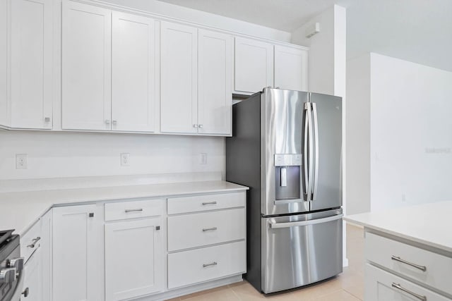 14180 Samoa Hill Ct, Riverview, FL 33569 - kitchen with stainless steel fridge with ice dispenser, white cabinetry, light countertops, and light tile patterned floors