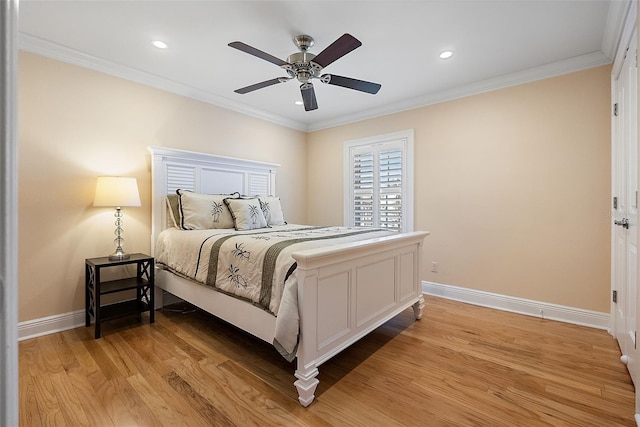 bedroom featuring crown molding, light wood-style floors, and baseboards