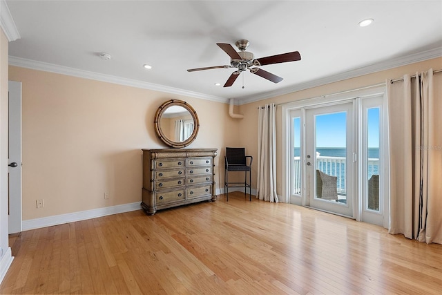 unfurnished bedroom featuring access to exterior, crown molding, and light wood-type flooring