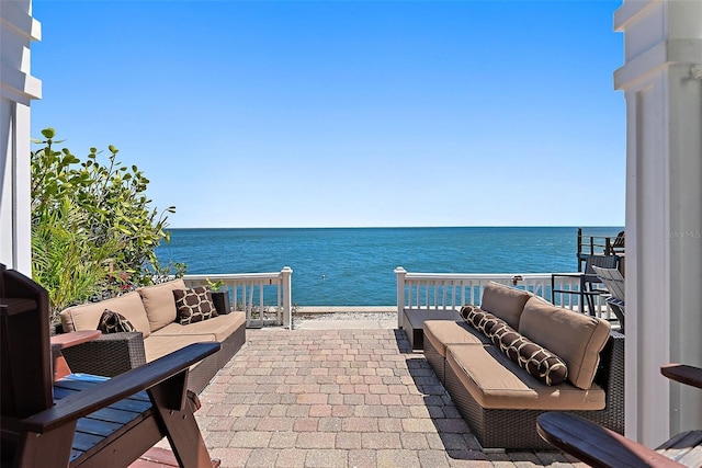 view of patio / terrace with an outdoor living space and a water view