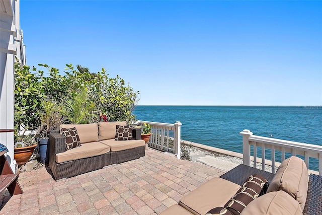 view of patio / terrace with outdoor lounge area and a water view