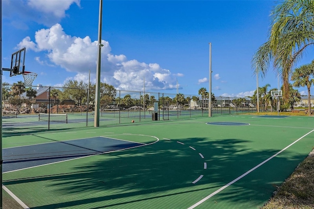 view of sport court with a tennis court, community basketball court, and fence