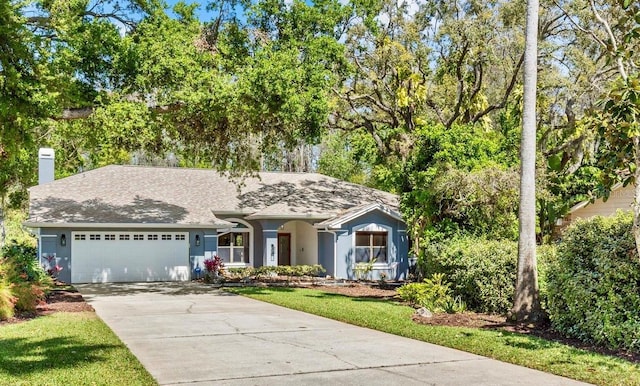 ranch-style house featuring concrete driveway, roof with shingles, stucco siding, a chimney, and an attached garage