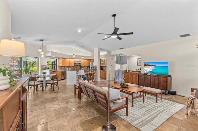 living room with baseboards, visible vents, ceiling fan, stone tile flooring, and vaulted ceiling