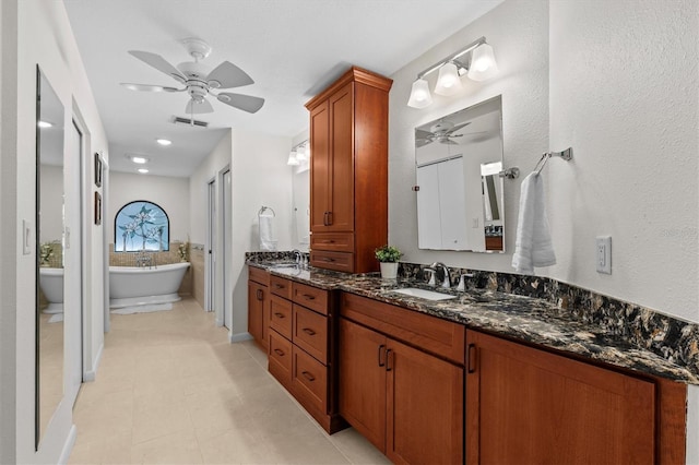 bathroom featuring vanity, a ceiling fan, visible vents, and a freestanding bath