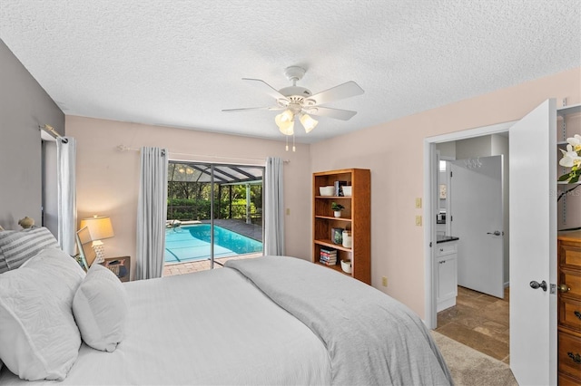 bedroom featuring light carpet, access to outside, a textured ceiling, a sunroom, and ceiling fan