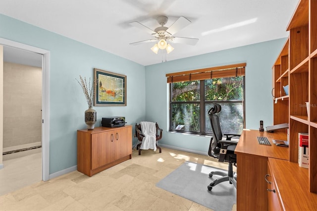 office featuring baseboards and ceiling fan