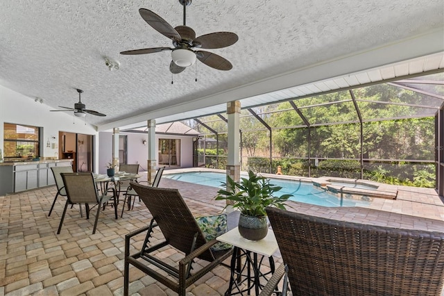 view of pool featuring ceiling fan, area for grilling, a lanai, and a patio area