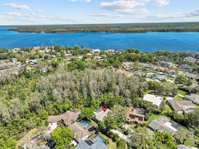 bird's eye view with a forest view and a water view