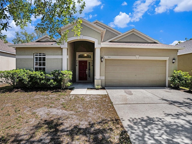 405 Laguna Mill Dr, Ruskin, FL 33570 - ranch-style home featuring a garage, concrete driveway, and stucco siding