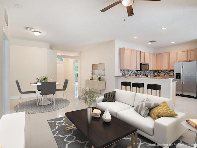 405 Laguna Mill Dr, Ruskin, FL 33570 - living room featuring arched walkways, ceiling fan, light tile patterned floors, and recessed lighting