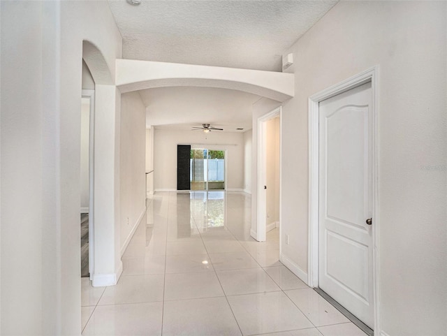 405 Laguna Mill Dr, Ruskin, FL 33570 - hallway with arched walkways and light tile patterned floors