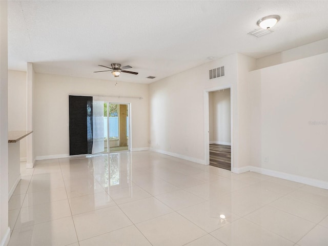 405 Laguna Mill Dr, Ruskin, FL 33570 - spare room with a ceiling fan, light tile patterned floors, and a textured ceiling