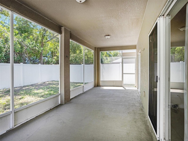 405 Laguna Mill Dr, Ruskin, FL 33570 - unfurnished sunroom with a textured ceiling and concrete floors