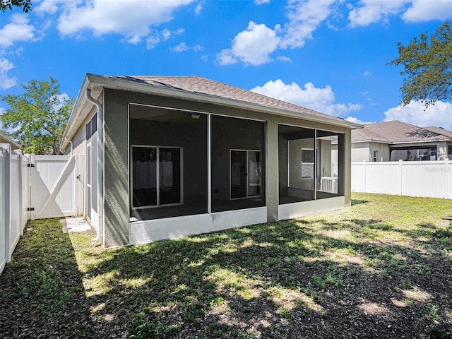 405 Laguna Mill Dr, Ruskin, FL 33570 - back of house featuring a gate, a fenced backyard, and a sunroom