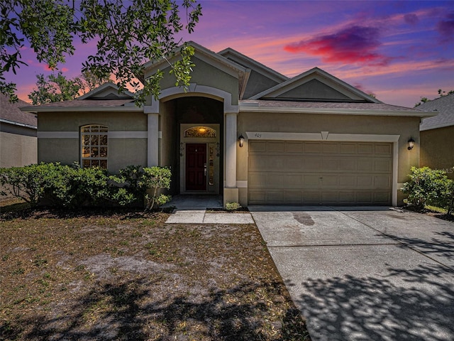 405 Laguna Mill Dr, Ruskin, FL 33570 - view of front of home with a garage, concrete driveway, and stucco siding