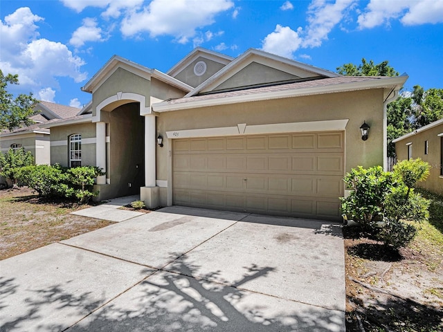 405 Laguna Mill Dr, Ruskin, FL 33570 - ranch-style house with stucco siding, a garage, and driveway