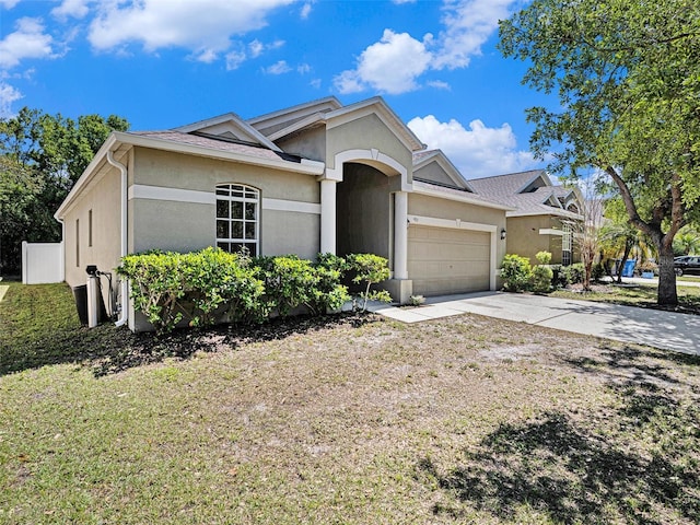 405 Laguna Mill Dr, Ruskin, FL 33570 - single story home with stucco siding, an attached garage, and concrete driveway