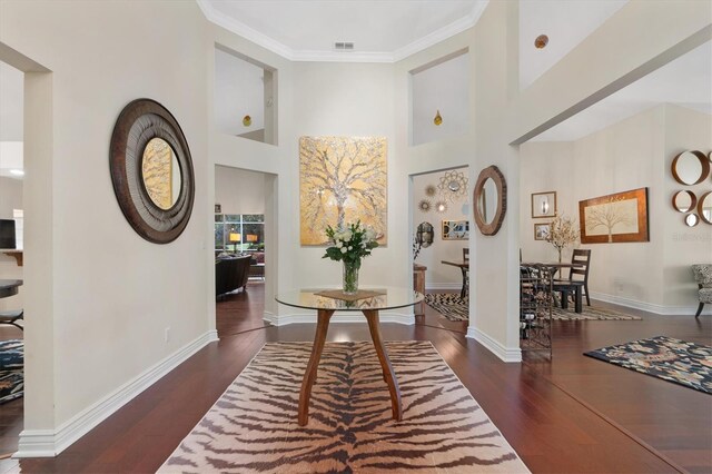 17503 Edinburgh Dr, Tampa, FL 33647 - entrance foyer with crown molding, wood finished floors, visible vents, and baseboards