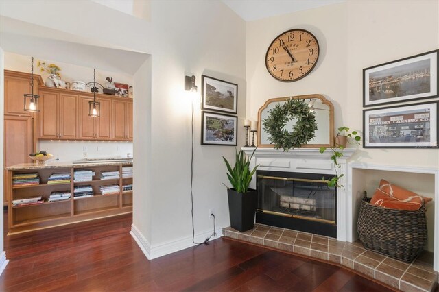 17503 Edinburgh Dr, Tampa, FL 33647 - living area featuring baseboards, dark wood-style flooring, and a tile fireplace