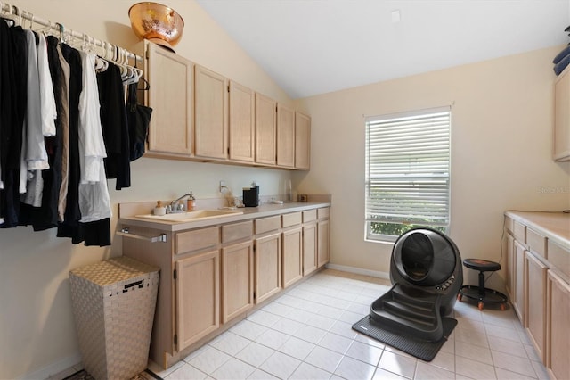 17503 Edinburgh Dr, Tampa, FL 33647 - laundry area featuring light tile patterned floors, baseboards, and a sink