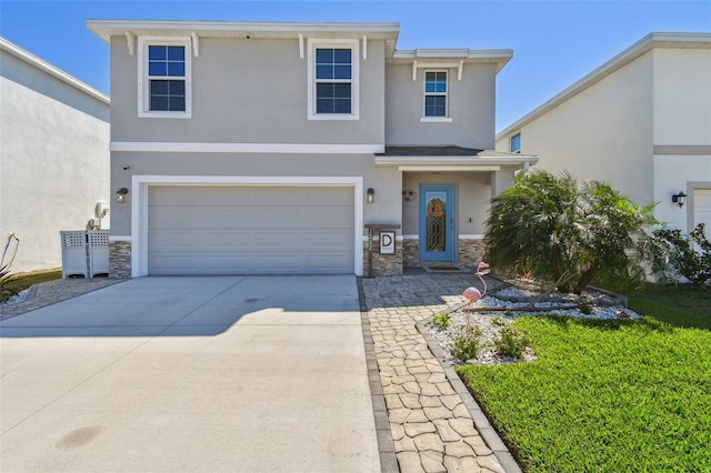 view of front of property with stone siding, stucco siding, an attached garage, and concrete driveway