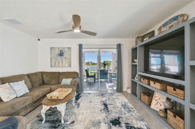 tiled living room with visible vents and a ceiling fan